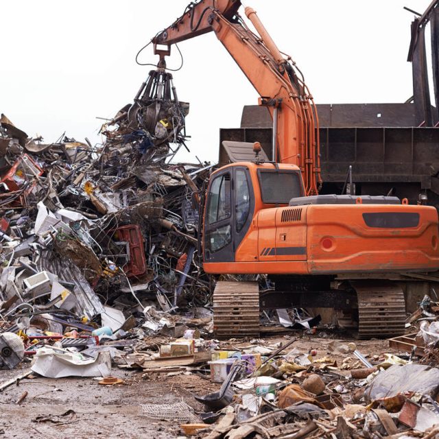 scrapyard-cropped-shot-excavator-sorting-through-pile-scrap-metal_Easy-Resize.com